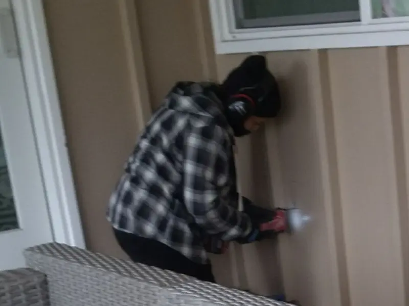 Professional electrician installing an exterior outlet in Mahoning
